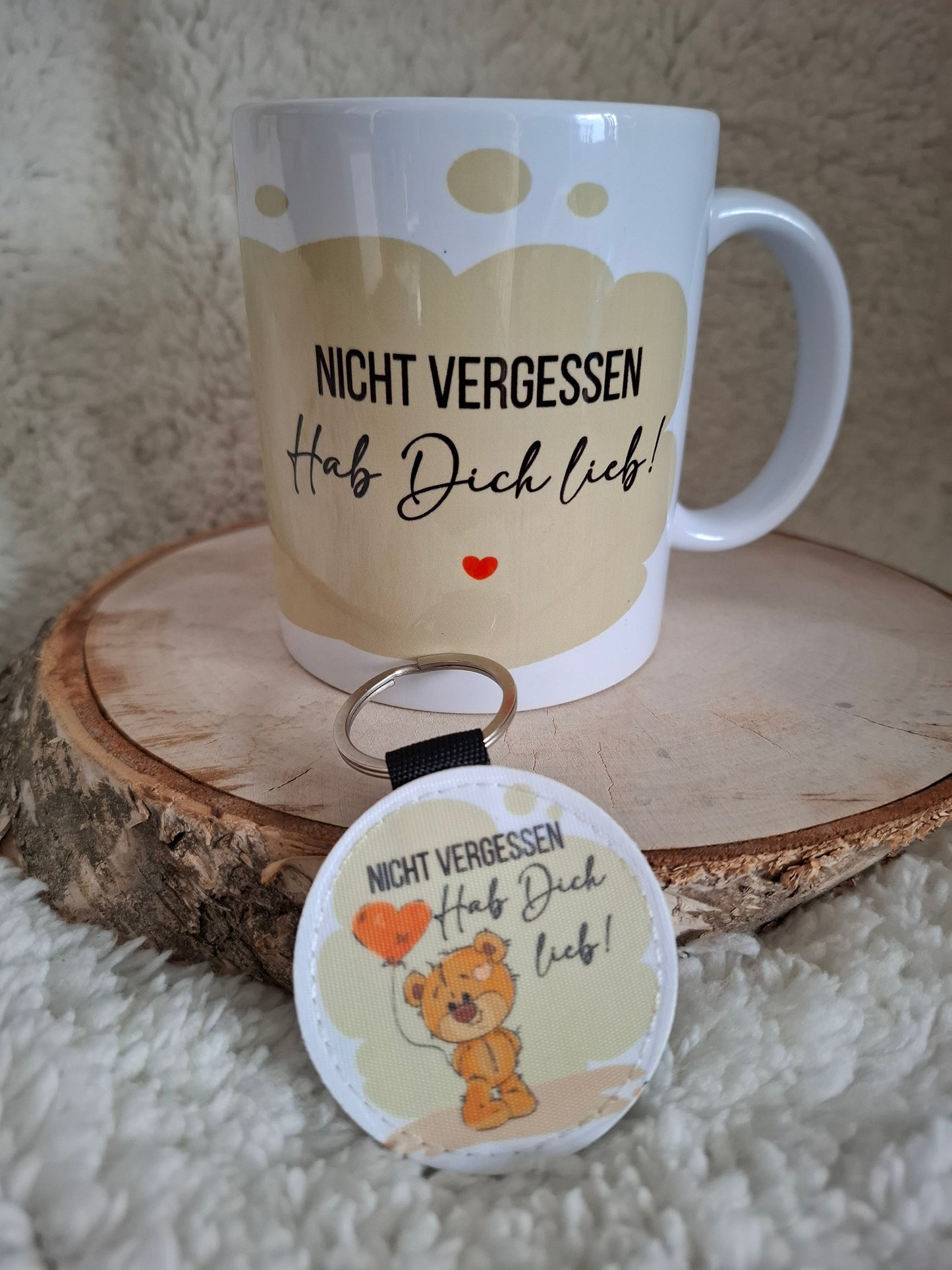 Kaffeebecher, die einen Bären mit Herzballon zeigen, ergänzt durch den Text "Hab Dich Lieb"