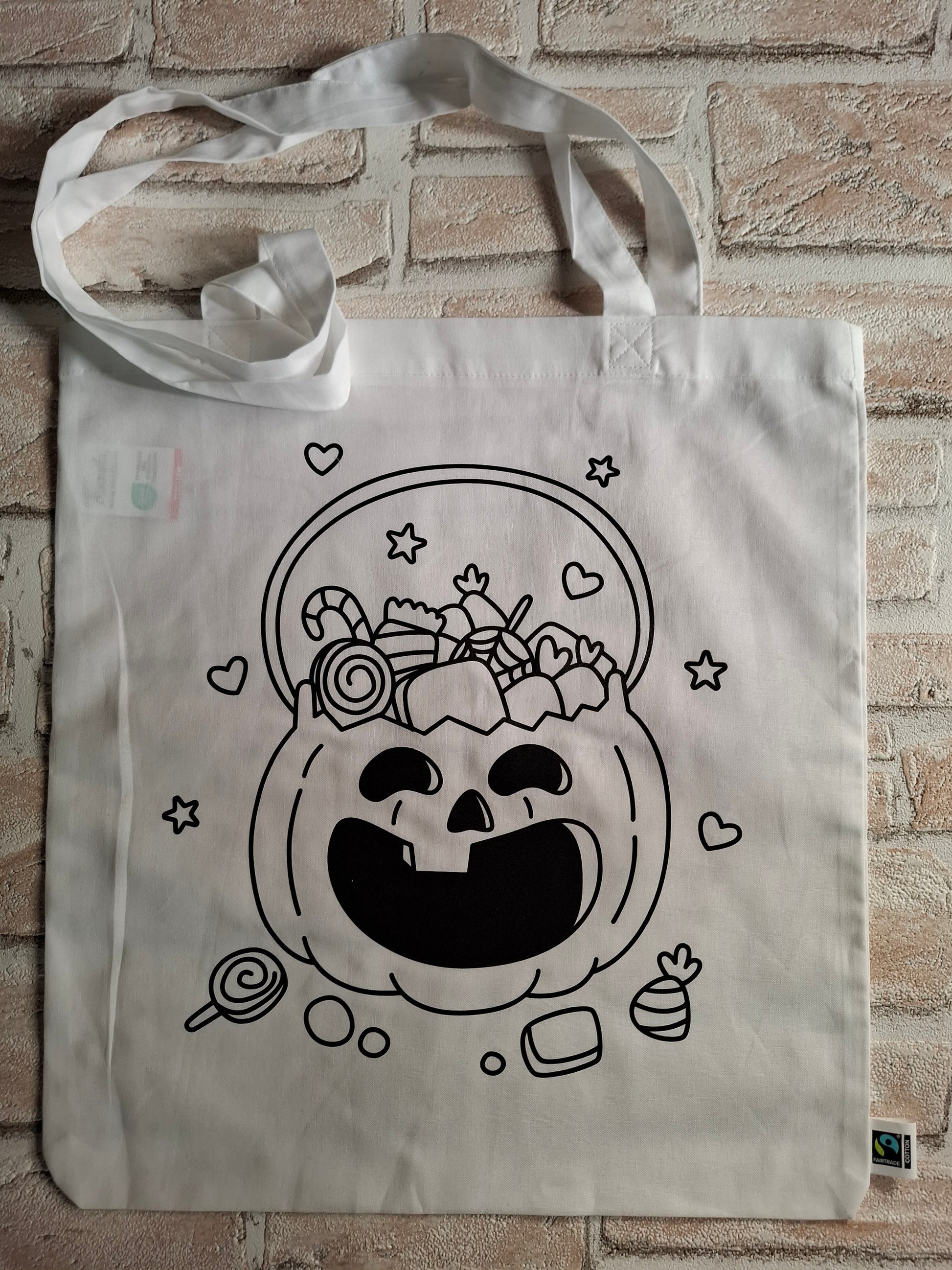 Baumwolltasche mit ausmalbarem Kürbis und Textilstiften, perfekt für Halloween und kreative Aktivitäten.