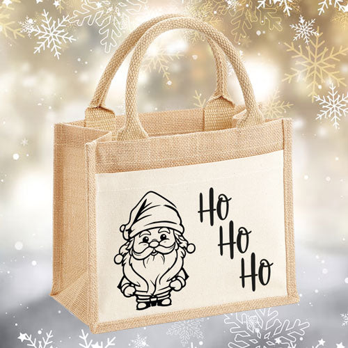 Kleine Jutetasche mit einem Santa Claus Design, perfekt als Geschenkverpackung für Weihnachten.