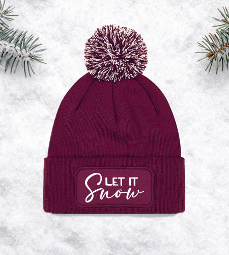 Coole Bommelmütze mit "Let It Snow" – bringt winterliche Freude in deinen Look.
